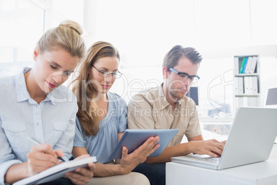 Concentrated three young people in office