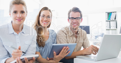 Portrait of three young people in office