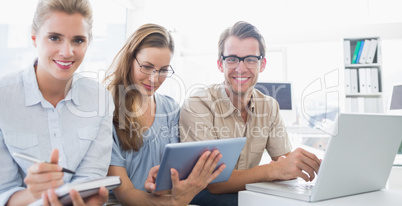 Portrait of three young people in office