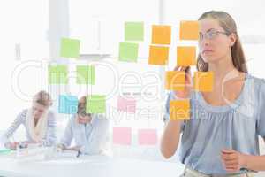 Concentrated artist looking at colorful sticky notes