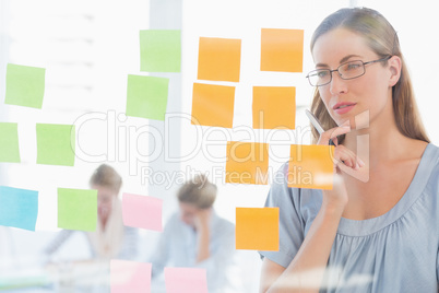 Concentrated artist looking at colorful sticky notes