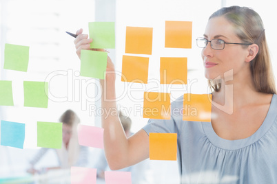 Concentrated artist looking at colorful sticky notes