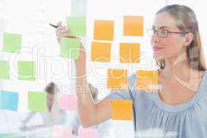 Concentrated artist looking at colorful sticky notes