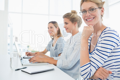 Three young people working in office