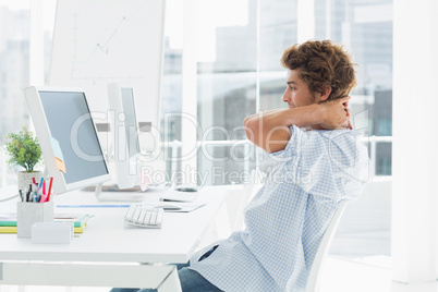 Casual business man using computer in bright office