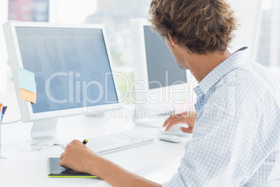 Artist drawing something on graphic tablet with pen