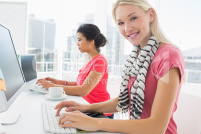 Casual young women using computers in office