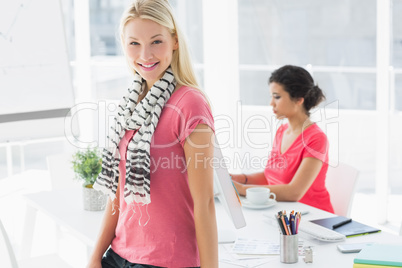 Casual business woman with colleague using computer