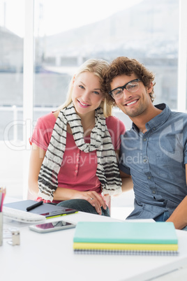 Casual business couple sitting in a bright office