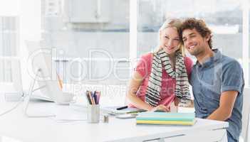 Smiling casual business couple in a bright office
