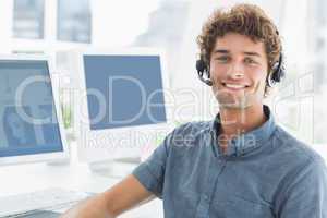 Smiling casual man with headset in the office