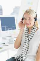 Smiling casual woman with headset in office