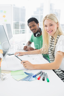 Casual couple using computer in office