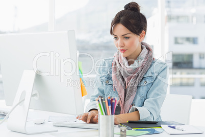 Casual woman using computer in office