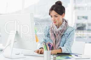 Casual woman using computer in office