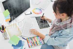 Artist drawing something on graphic tablet at office