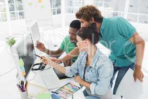 Three artists working on computer at office