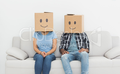 Couple with happy smiley boxes over faces