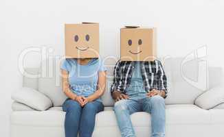 Couple with happy smiley boxes over faces