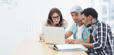 Artists working at desk in creative office