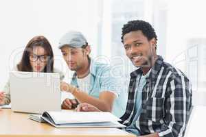 Artists working at desk in creative office