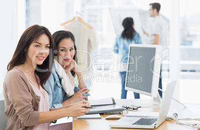 Female artists working at desk in creative office