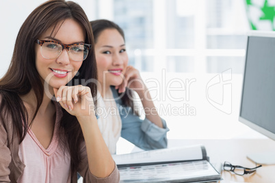 Casual female artists working at desk in office