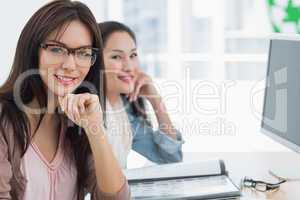 Casual female artists working at desk in office