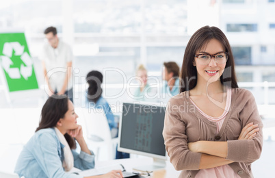 Female artist with colleagues in the background at office
