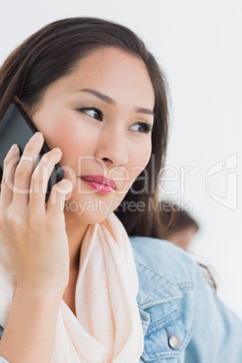 Beautiful casual woman using mobile phone in office