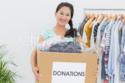 Young woman with clothes donation