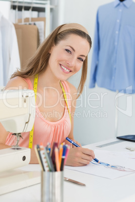 Smiling fashion designer working on her designs