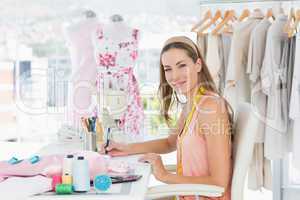 Portrait of a female fashion designer working on her designs