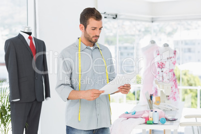 Fashion designer looking at sketch in the studio