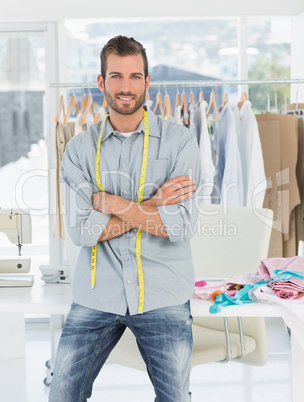 Handsome male fashion designer with arms crossed