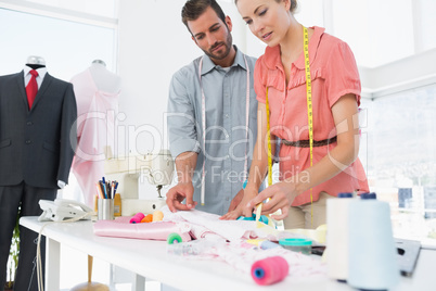 Fashion designers at work in bright studio