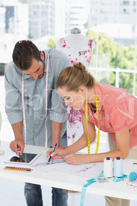 Fashion designers at work in bright studio