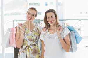 Happy women with shopping bags in clothes store