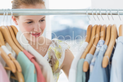 Female customer selecting clothes at store