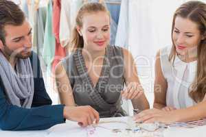 Three fashion designers discussing designs