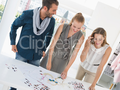 Three fashion designers discussing designs