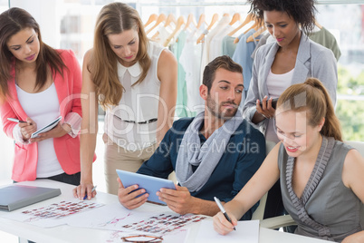 Fashion designers discussing designs