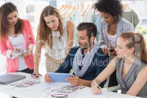 Fashion designers discussing designs