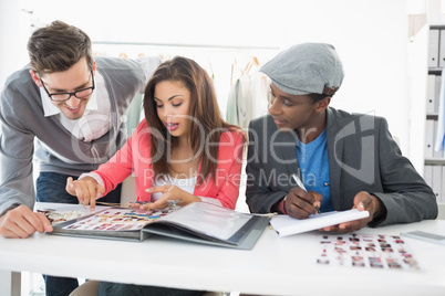 Fashion designers discussing designs