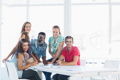Group portrait of casual artists working on designs