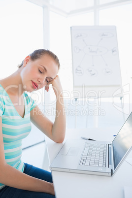 Casual woman sleeping in front of laptop at office