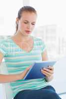 Beautiful young casual woman using digital tablet