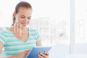 Beautiful young casual woman using digital tablet