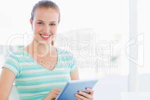 Beautiful young casual woman using digital tablet