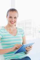 Beautiful young casual woman using digital tablet